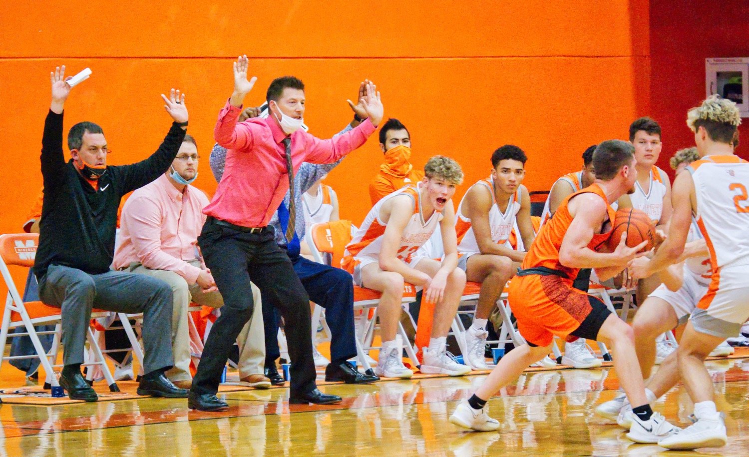 Coaches Brad Gibson, left, and Ryan Steadman, standing, implore their defenders, Jonah Fischer and TJ Moreland, to keep their hands up in the air. [see more shots and get prints here]